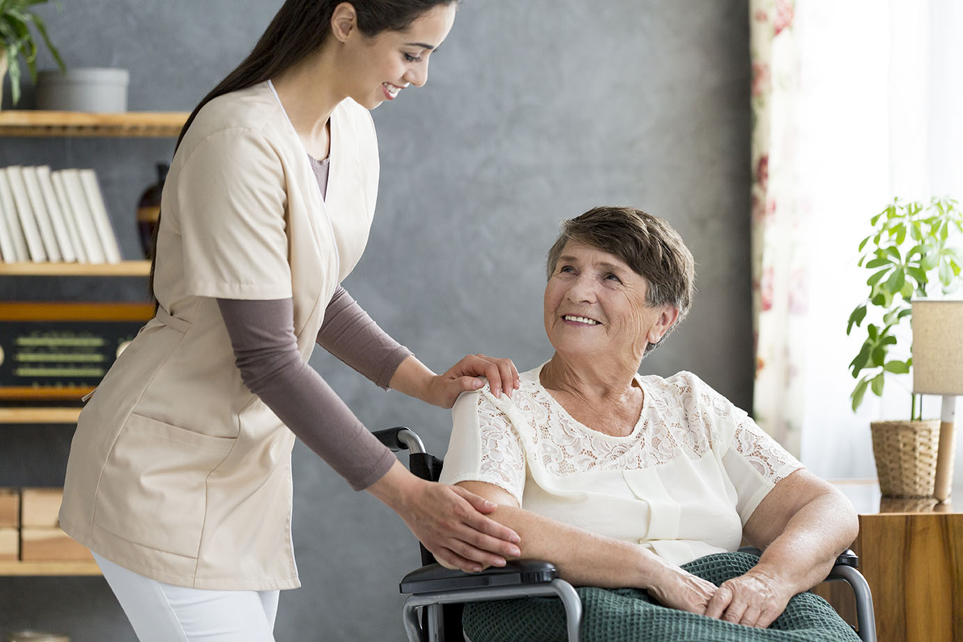 Nurse helping woman in wheelchair